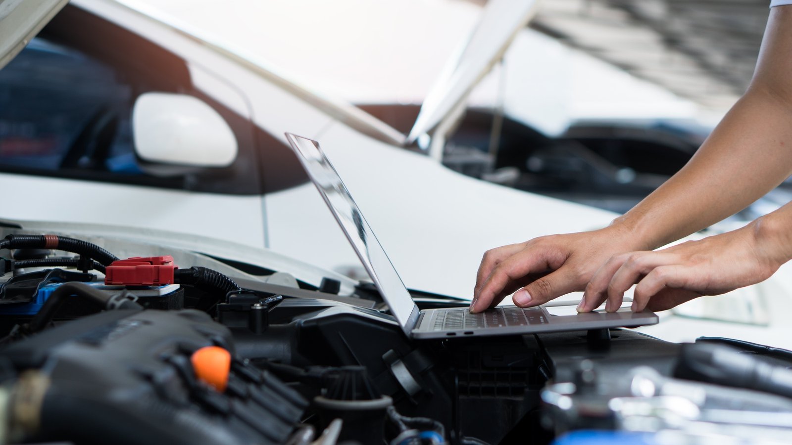 Car mechanic using a laptop computer to examine and tune ECU calibration data