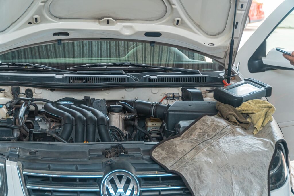 Mechanic connecting diagnostic laptop to a diesel van to diagnose AdBlue system fault